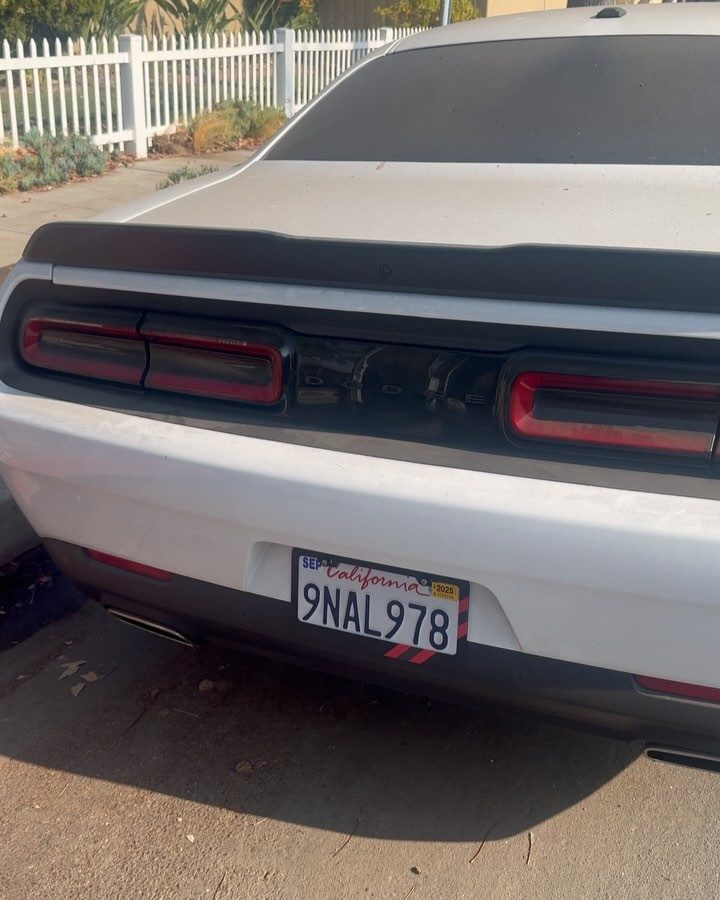 Black Dodge Challenger, rear, after a full detail